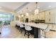 Open kitchen featuring a large island with seating, ample cabinetry, and modern lighting at 6102 Sonesta Ct, Bradenton, FL 34202