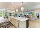 This kitchen features an open layout, quartz countertop island and is open to the living room and breakfast nook at 6102 Sonesta Ct, Bradenton, FL 34202