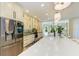Bright kitchen boasts stainless steel appliances, large island with quartz countertop, and open layout at 6102 Sonesta Ct, Bradenton, FL 34202