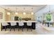 Large kitchen island with bar stools adjacent to a bright dining area at 6102 Sonesta Ct, Bradenton, FL 34202