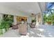 Enclosed Lanai features wicker furniture and tropical garden views, creating a perfect outdoor relaxation space at 6102 Sonesta Ct, Bradenton, FL 34202
