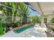Beautiful outdoor living space complete with jacuzzi and lush landscaping views in the lanai at 6102 Sonesta Ct, Bradenton, FL 34202