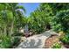 Lush landscaping featuring vibrant tropical plants and winding gravel paths, creating a serene garden setting at 6102 Sonesta Ct, Bradenton, FL 34202