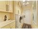 Bright laundry room with modern washer, dryer, ample storage, and elegant lighting at 6102 Sonesta Ct, Bradenton, FL 34202
