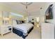 A view of the main bedroom with high ceiling, stylish furnishings, and an open doorway to another room at 6102 Sonesta Ct, Bradenton, FL 34202