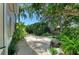 Stone path lined with lush greenery and mature trees, creating a serene and inviting outdoor space at 6102 Sonesta Ct, Bradenton, FL 34202