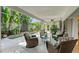 Screened-in patio with comfortable seating area overlooking the pool and lush landscaping at 6102 Sonesta Ct, Bradenton, FL 34202