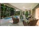 Screened-in patio with comfortable seating area overlooking the pool and lush landscaping at 6102 Sonesta Ct, Bradenton, FL 34202