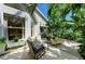 Charming patio space featuring comfortable wicker chairs, landscaped garden, and views of the home's exterior at 6102 Sonesta Ct, Bradenton, FL 34202