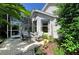 Cozy outdoor patio featuring comfortable seating, screened-in lanai, and a beautifully landscaped garden at 6102 Sonesta Ct, Bradenton, FL 34202