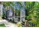 Exterior view of a patio with lush greenery and potted plants along the walkway at 6102 Sonesta Ct, Bradenton, FL 34202