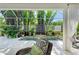Beautiful pool with decorative fountain, surrounded by lush, tropical plants on a screened patio at 6102 Sonesta Ct, Bradenton, FL 34202
