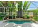 Indoor pool with decorative fountain and tropical plants, offering a tranquil and luxurious experience at 6102 Sonesta Ct, Bradenton, FL 34202