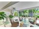 Inviting sunroom boasts comfortable wicker seating and views of the tranquil outdoor space at 6102 Sonesta Ct, Bradenton, FL 34202