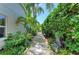 Charming walkway lined with lush greenery and mature trees, leading to a private gate at 6102 Sonesta Ct, Bradenton, FL 34202
