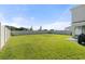 Expansive backyard with lush green grass, a white privacy fence, and ample space for outdoor activities and relaxation at 6314 Distant Haze Pl, Palmetto, FL 34221