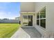 Backyard patio area with sliding glass doors and views of the lawn at 6314 Distant Haze Pl, Palmetto, FL 34221