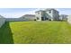 Expansive backyard with green lawn, privacy fence, and home exterior at 6314 Distant Haze Pl, Palmetto, FL 34221
