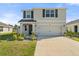 Charming two-story home with a well-maintained lawn and a spacious two-car garage at 6314 Distant Haze Pl, Palmetto, FL 34221