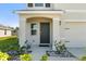 Inviting front entry with manicured landscaping, covered porch, and a freshly painted front door at 6314 Distant Haze Pl, Palmetto, FL 34221