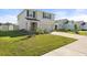 Charming home featuring a lush green lawn, tasteful landscaping, and a driveway leading to an attached two-car garage at 6314 Distant Haze Pl, Palmetto, FL 34221