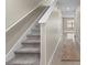 Hallway with carpeted stairs and view of the living area and neutral walls at 6314 Distant Haze Pl, Palmetto, FL 34221