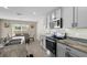 Well-equipped kitchen with granite counters, stainless appliances, and light gray cabinets at 6314 Distant Haze Pl, Palmetto, FL 34221