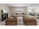 Bright and inviting living room with stylish furniture, a large window, and an adjacent dining area at 6314 Distant Haze Pl, Palmetto, FL 34221