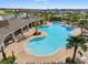 Aerial view of the community pool, featuring a spacious layout, seating areas, and lush landscaping at 6314 Distant Haze Pl, Palmetto, FL 34221