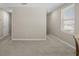 Spacious room with neutral walls and carpet flooring, ample natural light from a window at 6314 Distant Haze Pl, Palmetto, FL 34221