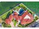 Stunning aerial view of a luxury home with a red tile roof, pool, lush landscaping, and waterfront access at 641 Ranger Ln, Longboat Key, FL 34228