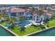Gorgeous backyard with a sparkling pool, spa, manicured lawn, and beautiful landscaping on the waterfront at 641 Ranger Ln, Longboat Key, FL 34228