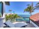 Outdoor balcony area featuring clear railings with an outdoor lounge chair and beautiful ocean views at 641 Ranger Ln, Longboat Key, FL 34228