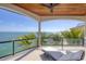 Relaxing balcony with water view, featuring a lounge chair and stylish glass railing for an unobstructed view at 641 Ranger Ln, Longboat Key, FL 34228