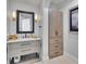 Well-lit bathroom featuring a vanity, cabinet, and decorative lighting at 641 Ranger Ln, Longboat Key, FL 34228