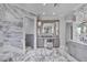 Luxurious bathroom with marble walls, floors, vanity, and makeup area, providing elegant finishes at 641 Ranger Ln, Longboat Key, FL 34228