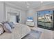 Bedroom with water view featuring tile floor, large windows and sliding glass doors and a ceiling fan at 641 Ranger Ln, Longboat Key, FL 34228