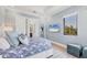 Beautiful bedroom with a large window, a blue patterned bedspread, and modern accents at 641 Ranger Ln, Longboat Key, FL 34228
