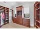 Spacious walk-in closet with custom shelving, drawers, and ample storage for clothes and accessories at 641 Ranger Ln, Longboat Key, FL 34228