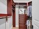 Walk-in closet featuring custom shelving and storage options for organizing wardrobe and accessories at 641 Ranger Ln, Longboat Key, FL 34228
