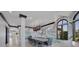 Formal dining room with unique mural, modern chandelier, seating for ten, and water view windows at 641 Ranger Ln, Longboat Key, FL 34228
