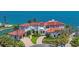 Mediterranean waterfront home with tile roof, separate garage, and luscious landscaping at 641 Ranger Ln, Longboat Key, FL 34228