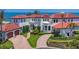 Lovely Mediterranean home featuring a brick circular drive, luscious green lawn and separate garage at 641 Ranger Ln, Longboat Key, FL 34228