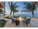 Outdoor fire pit with comfortable seating and scenic waterfront views at 641 Ranger Ln, Longboat Key, FL 34228