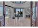 Bright foyer with views to a grand room, waterway and a staircase at 641 Ranger Ln, Longboat Key, FL 34228
