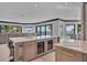 Elegant kitchen featuring island with wine storage, bar seating and a view to the outside at 641 Ranger Ln, Longboat Key, FL 34228