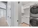 Laundry area featuring white cabinets, countertop, and a stacked washer/dryer at 641 Ranger Ln, Longboat Key, FL 34228