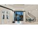 Spacious living room featuring water views, a staircase, and modern decor in neutral tones at 641 Ranger Ln, Longboat Key, FL 34228