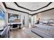 This main bedroom features a trey ceiling, light wood floors, and large window with beautiful water views at 641 Ranger Ln, Longboat Key, FL 34228