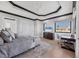 Bright main bedroom features tray ceilings, a ceiling fan, and a large window with neighborhood views at 641 Ranger Ln, Longboat Key, FL 34228